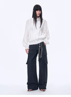 Person wearing a white jacket and black pants on a white background
