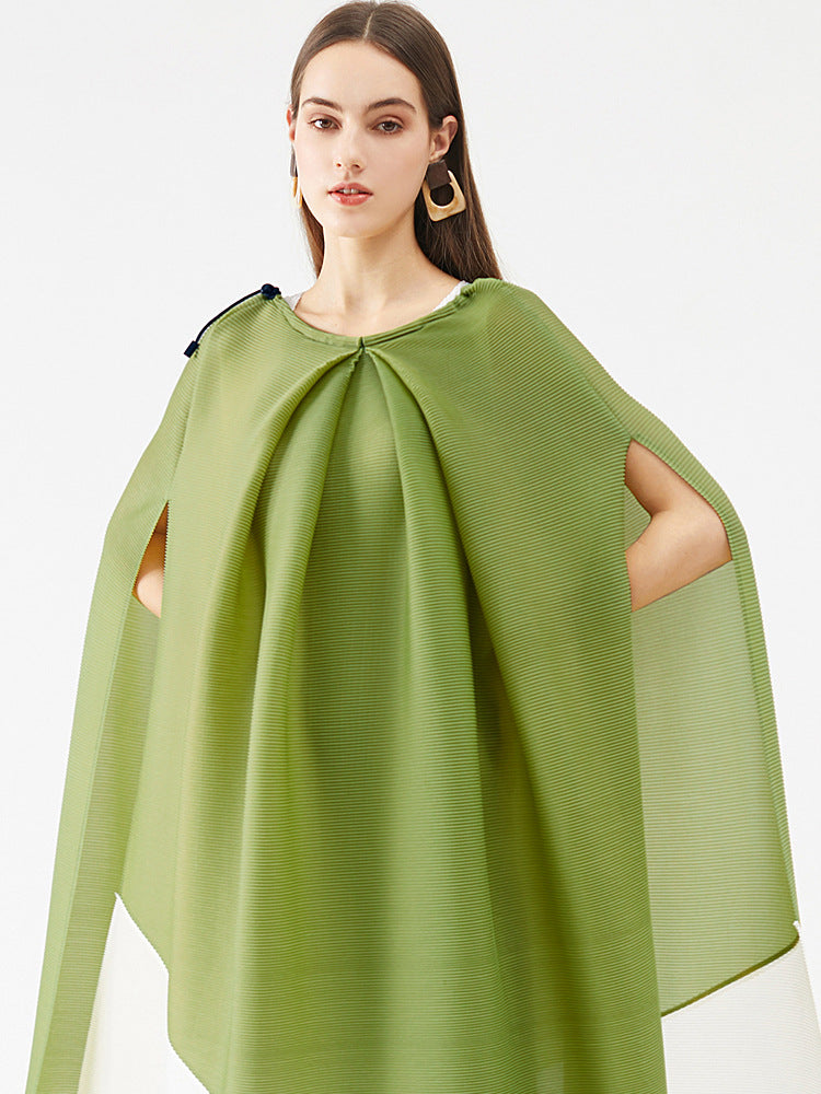 Woman wearing a green cape on a white background