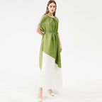 Woman wearing a green and white dress on a white background