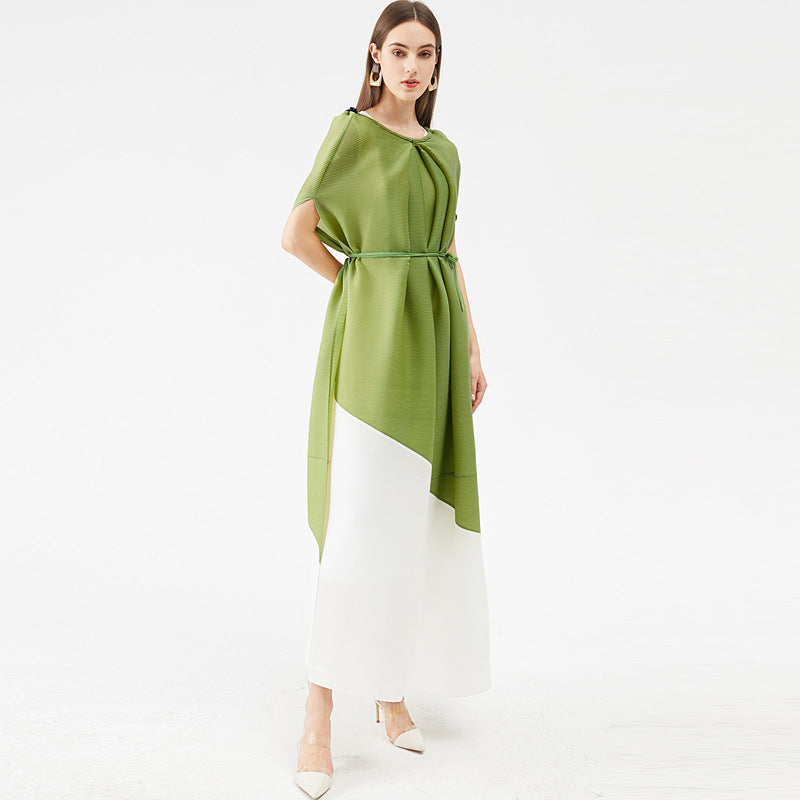 Woman wearing a green and white dress on a white background