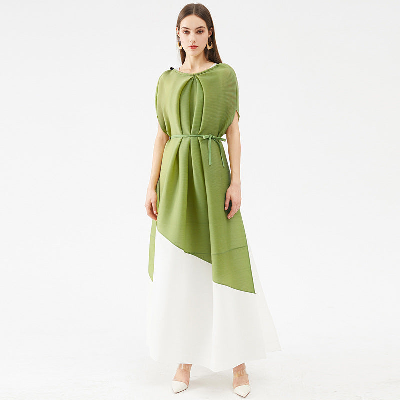 Woman wearing a green dress with a belt on a white background