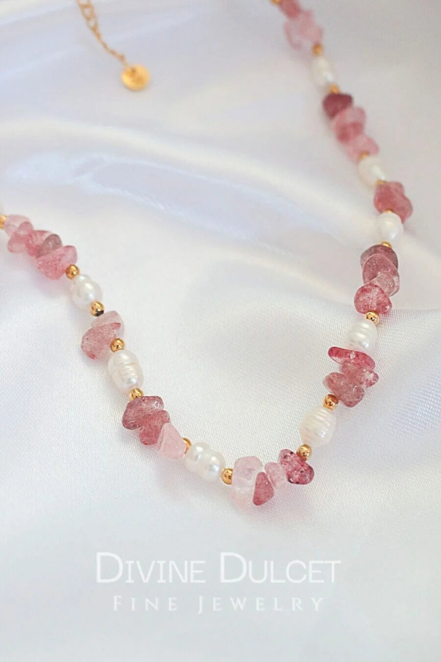 Necklace with pink beads and pearls on a white background, featuring 'Divine Dulcet Fine Jewelry'.
