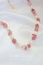 Necklace with pink beads and pearls on a white background, featuring 'Divine Dulcet Fine Jewelry'.