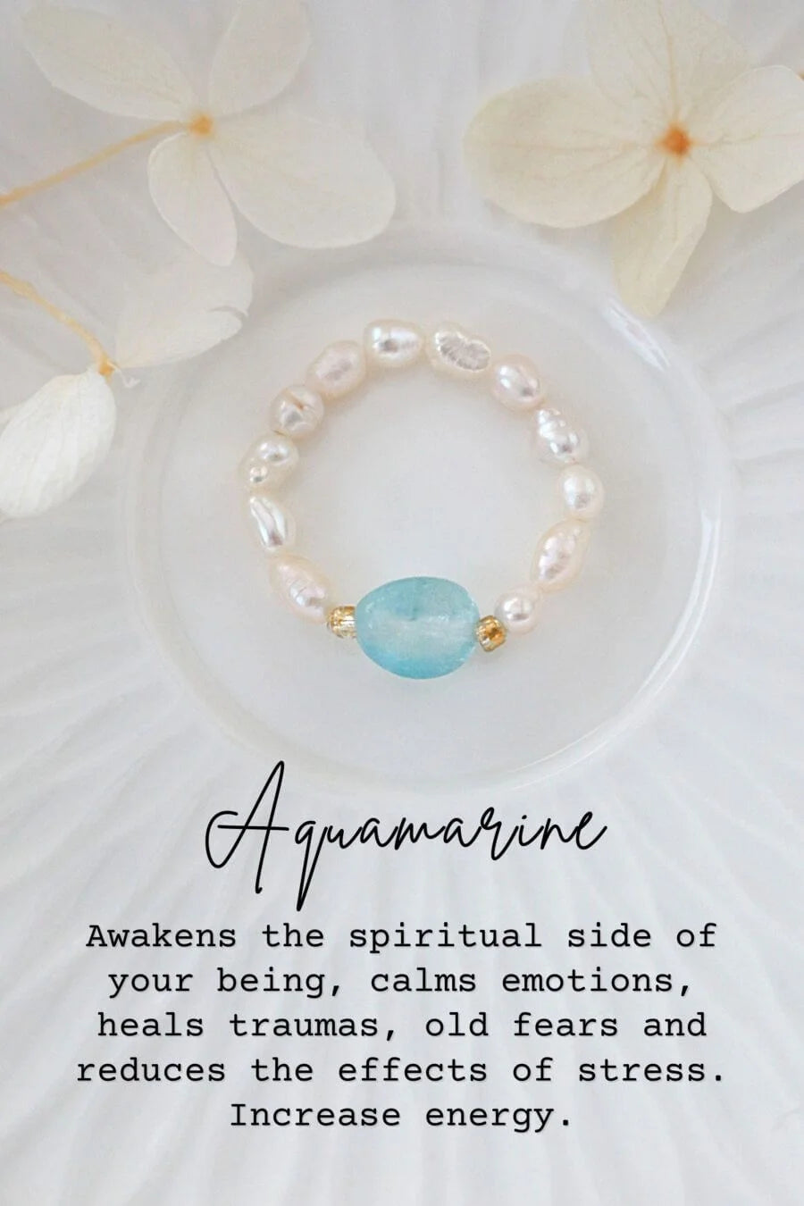 Pearl bracelet with a blue gemstone on a white background with flowers, text about aquamarine's properties.