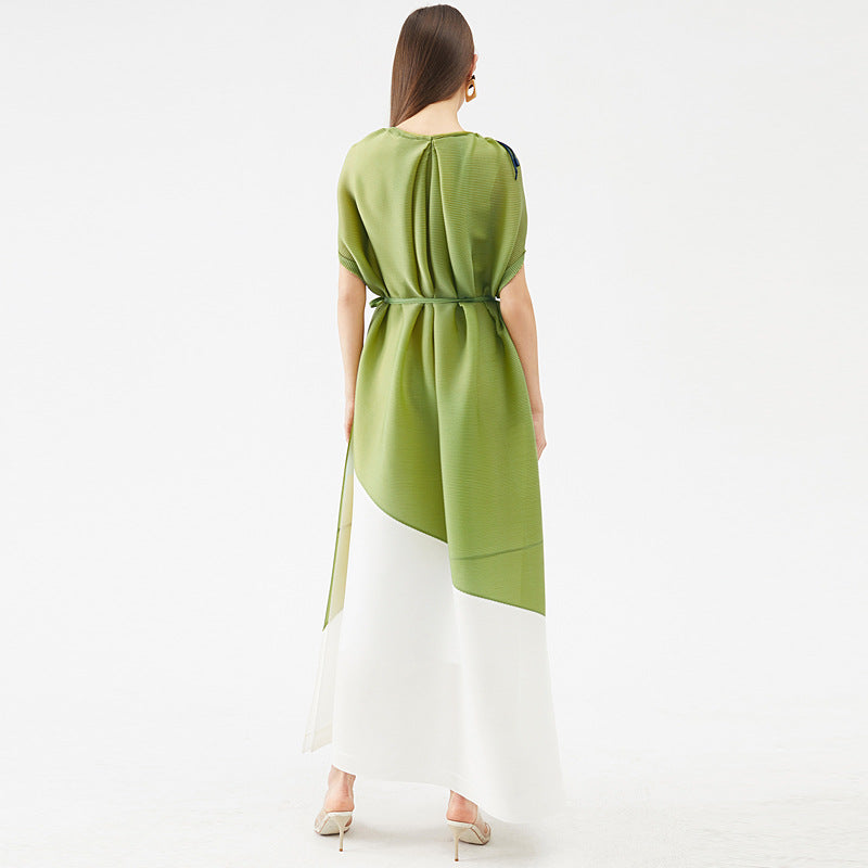 Woman wearing a green and white dress on a white background