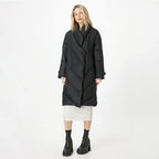Woman wearing a black coat on a white background