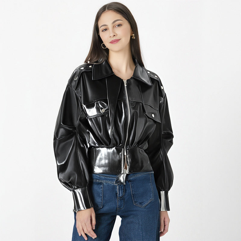 Woman wearing a black and silver jacket with blue jeans on a white background