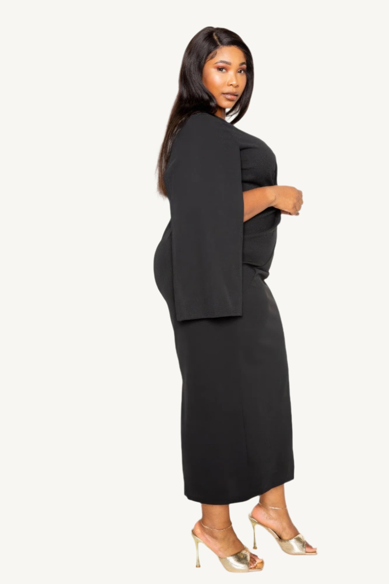 "Timeless black cape sleeve dress with front knot detail, tailored for elegance and comfort — perfect for formal or special occasions."