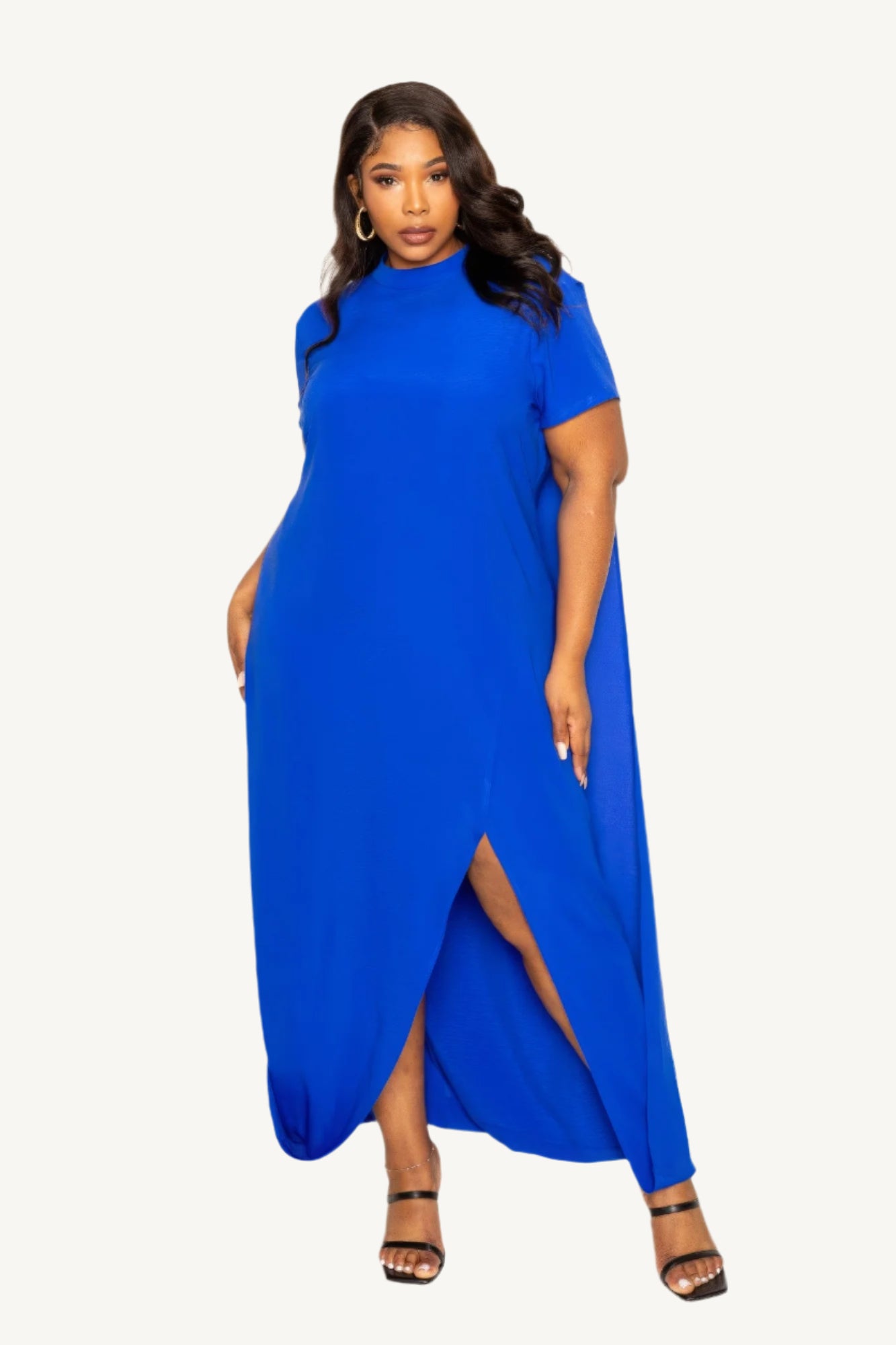 "Mock neck dress with flowing back cape detail, offering a modern silhouette with timeless elegance — perfect for formal and evening occasions."