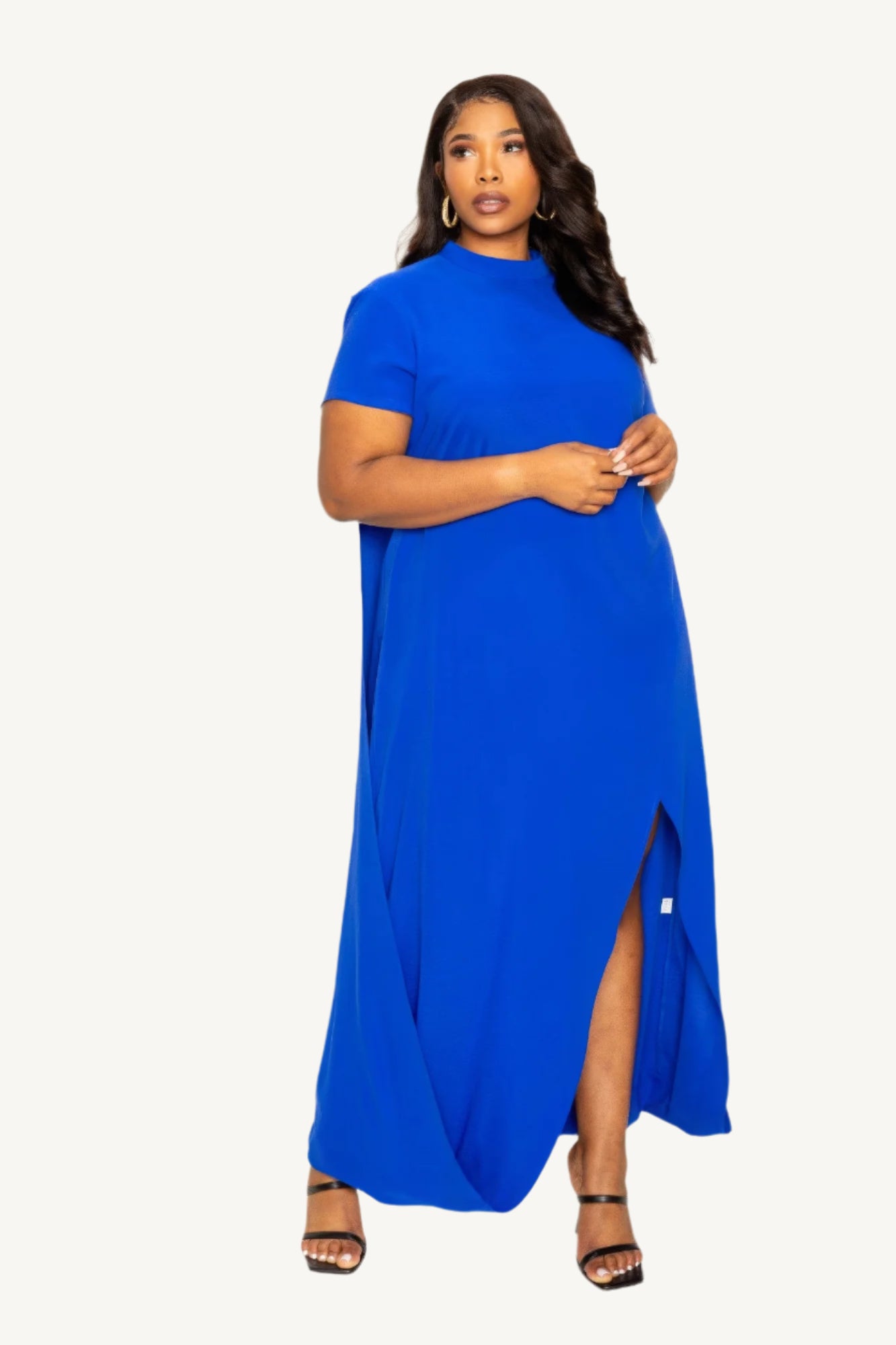 "Mock neck dress with flowing back cape detail, offering a modern silhouette with timeless elegance — perfect for formal and evening occasions."
