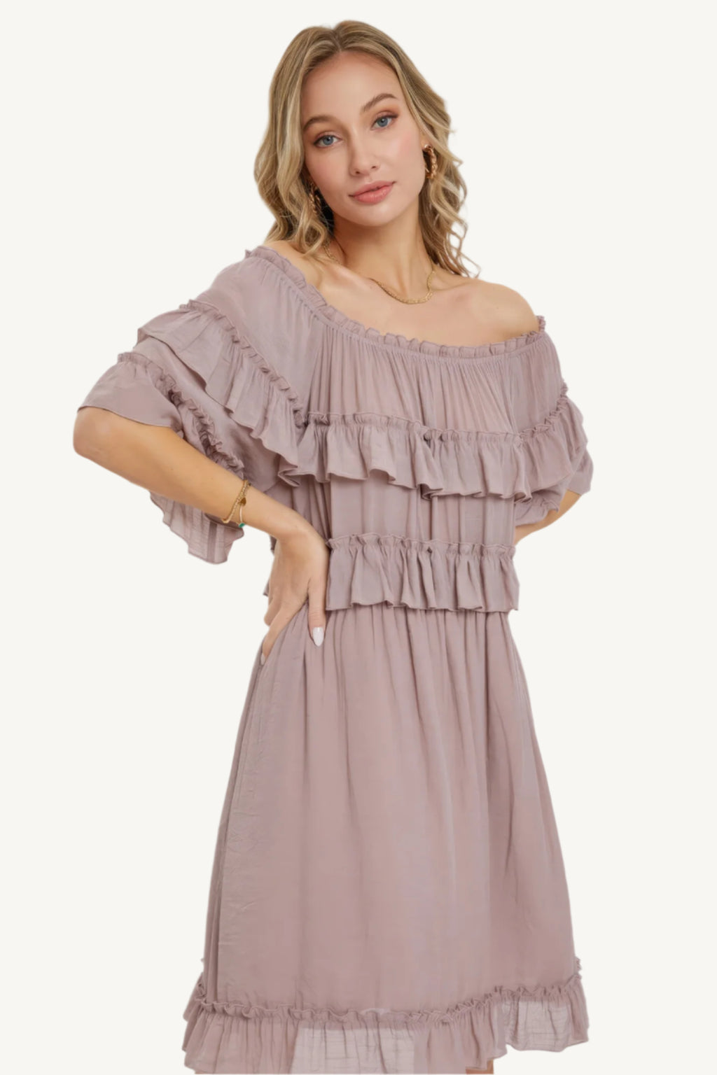 "Mystic mauve off-shoulder bohemian dress with short sleeves, elastic waist, and ruffle bottom, offering a relaxed fit and feminine silhouette."