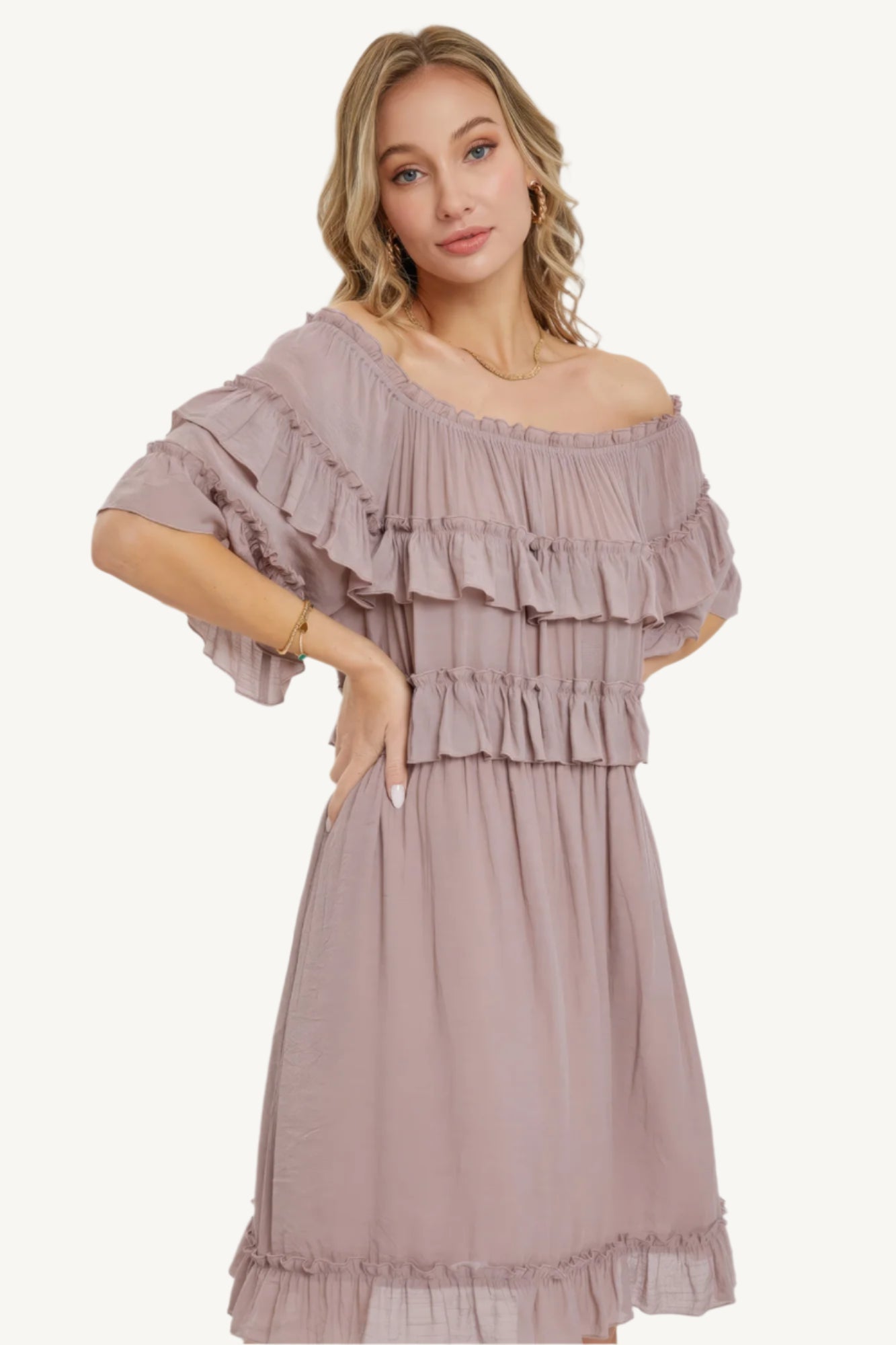 "Mystic mauve off-shoulder bohemian dress with short sleeves, elastic waist, and ruffle bottom, offering a relaxed fit and feminine silhouette."