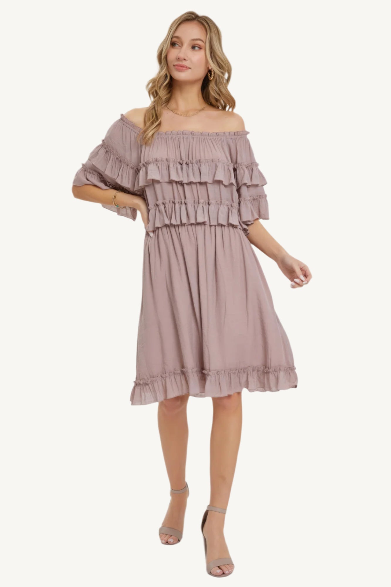 "Mystic mauve off-shoulder bohemian dress with short sleeves, elastic waist, and ruffle bottom, offering a relaxed fit and feminine silhouette."