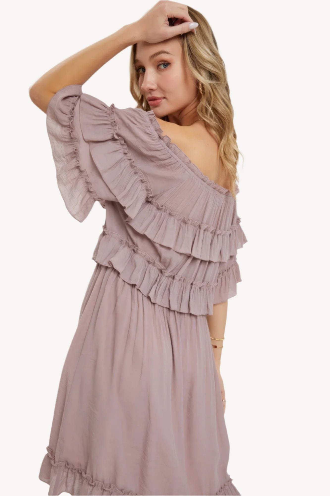 "Mystic mauve off-shoulder bohemian dress with short sleeves, elastic waist, and ruffle bottom, offering a relaxed fit and feminine silhouette."