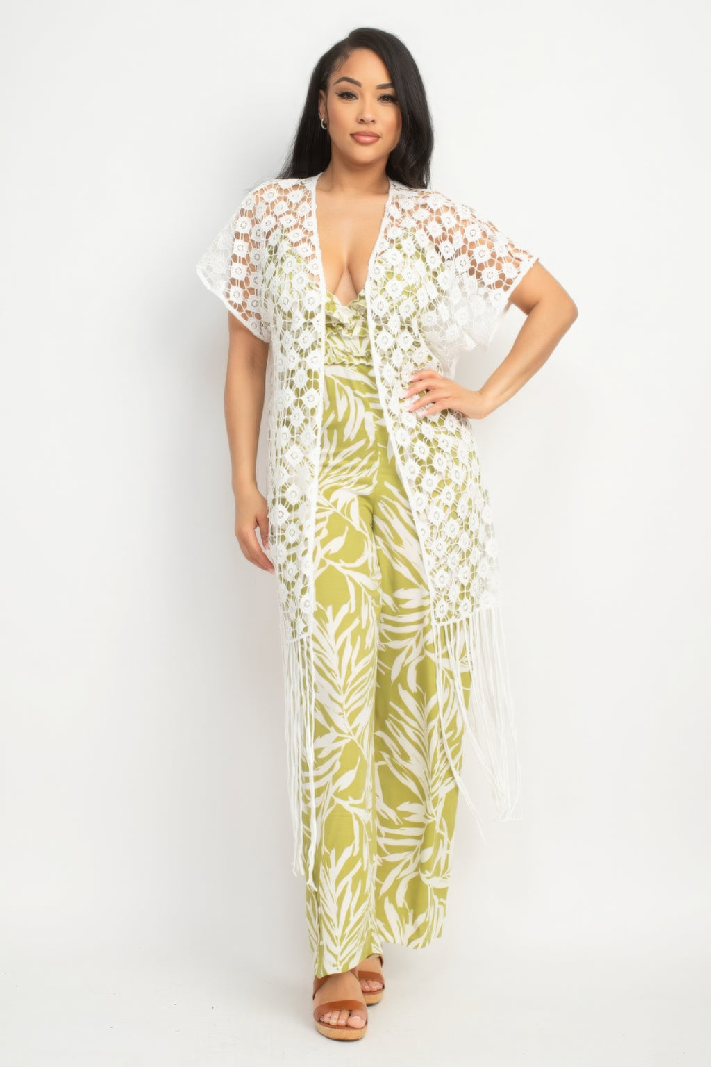 Woman wearing a floral jumpsuit with a matching cover-up on a white background