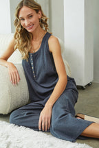 Woman wearing a blue dress sitting on a white rug.