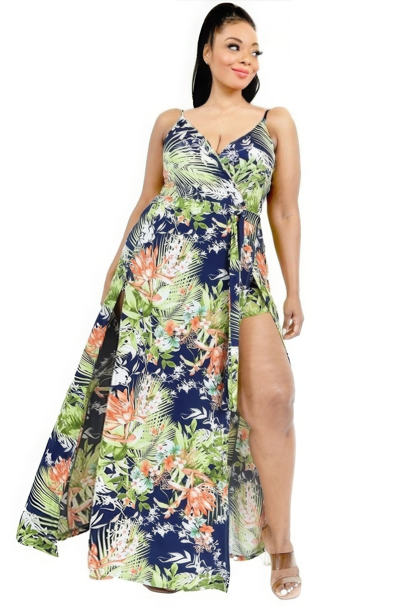 Woman wearing a floral dress with a slit on a white background