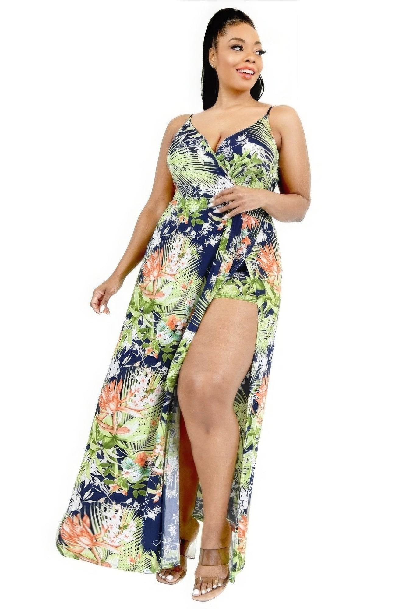Woman wearing a floral dress with a slit on a white background