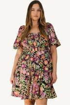 "Plus size floral printed mini dress with center tie-back detail, designed for a flattering, feminine, and comfortable fit."