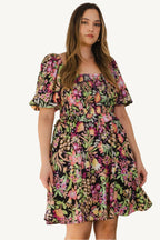 "Plus size floral printed mini dress with center tie-back detail, designed for a flattering, feminine, and comfortable fit."