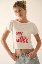 Woman wearing a white t-shirt with red text and stars on a plain background