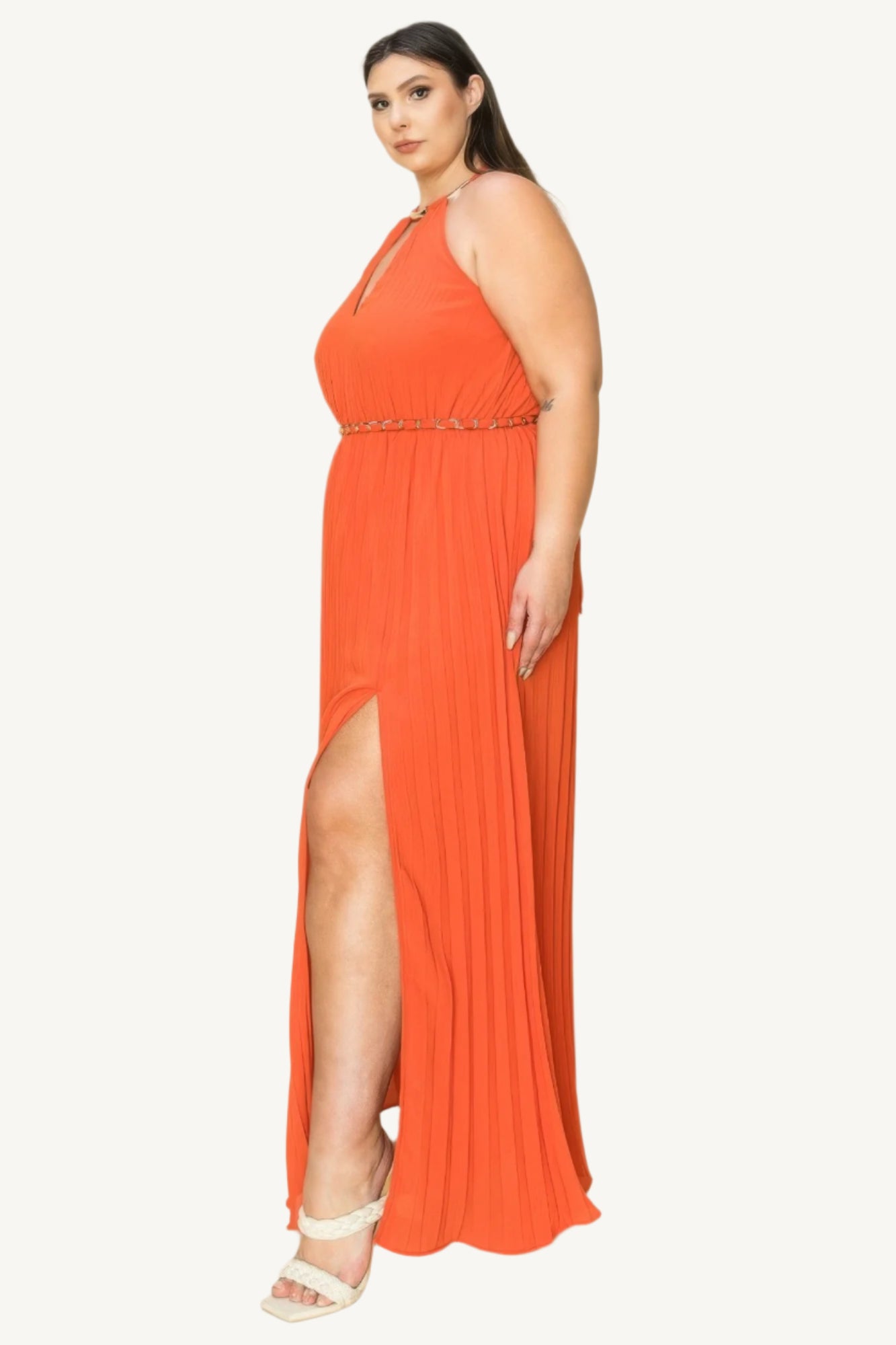 "Chiffon pleated maxi dress with gold trim neckline, cut-out chest detail, and matching belt, designed for a timeless and elegant look."