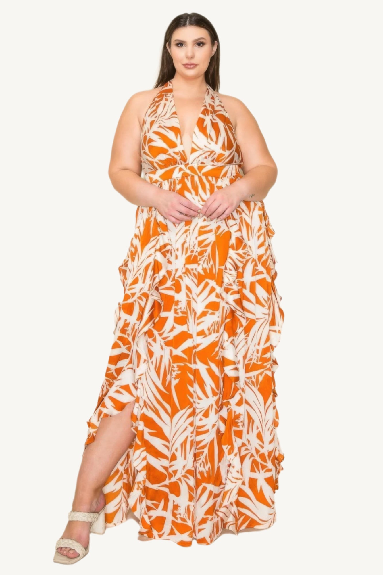 "Crinkle satin printed halter maxi dress with ruffle details, smocked waist, and front slit, offering a flowy, elegant, and flattering silhouette."