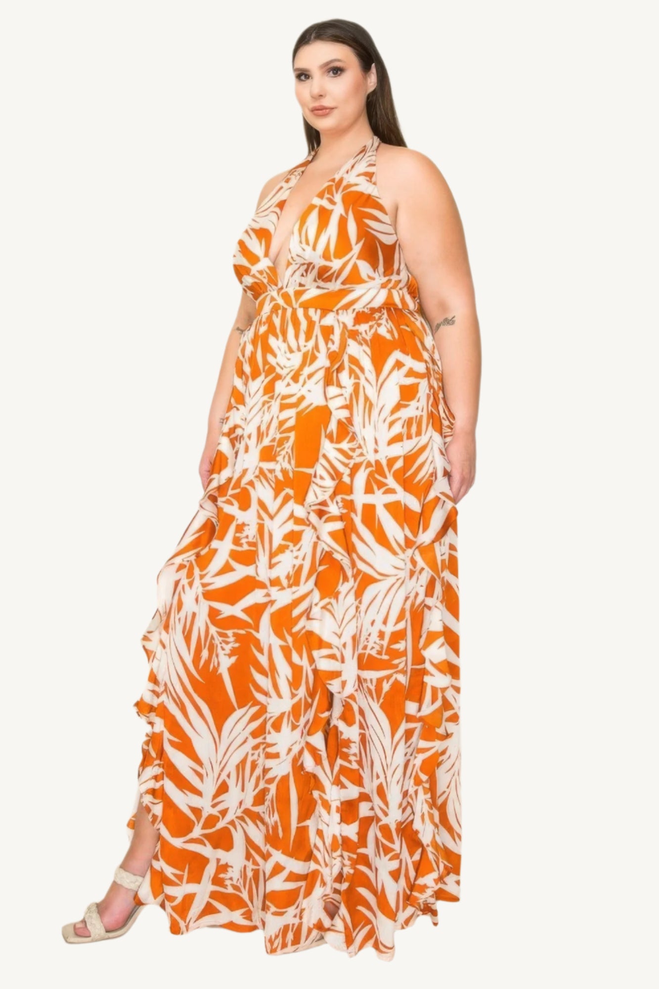 "Crinkle satin printed halter maxi dress with ruffle details, smocked waist, and front slit, offering a flowy, elegant, and flattering silhouette."