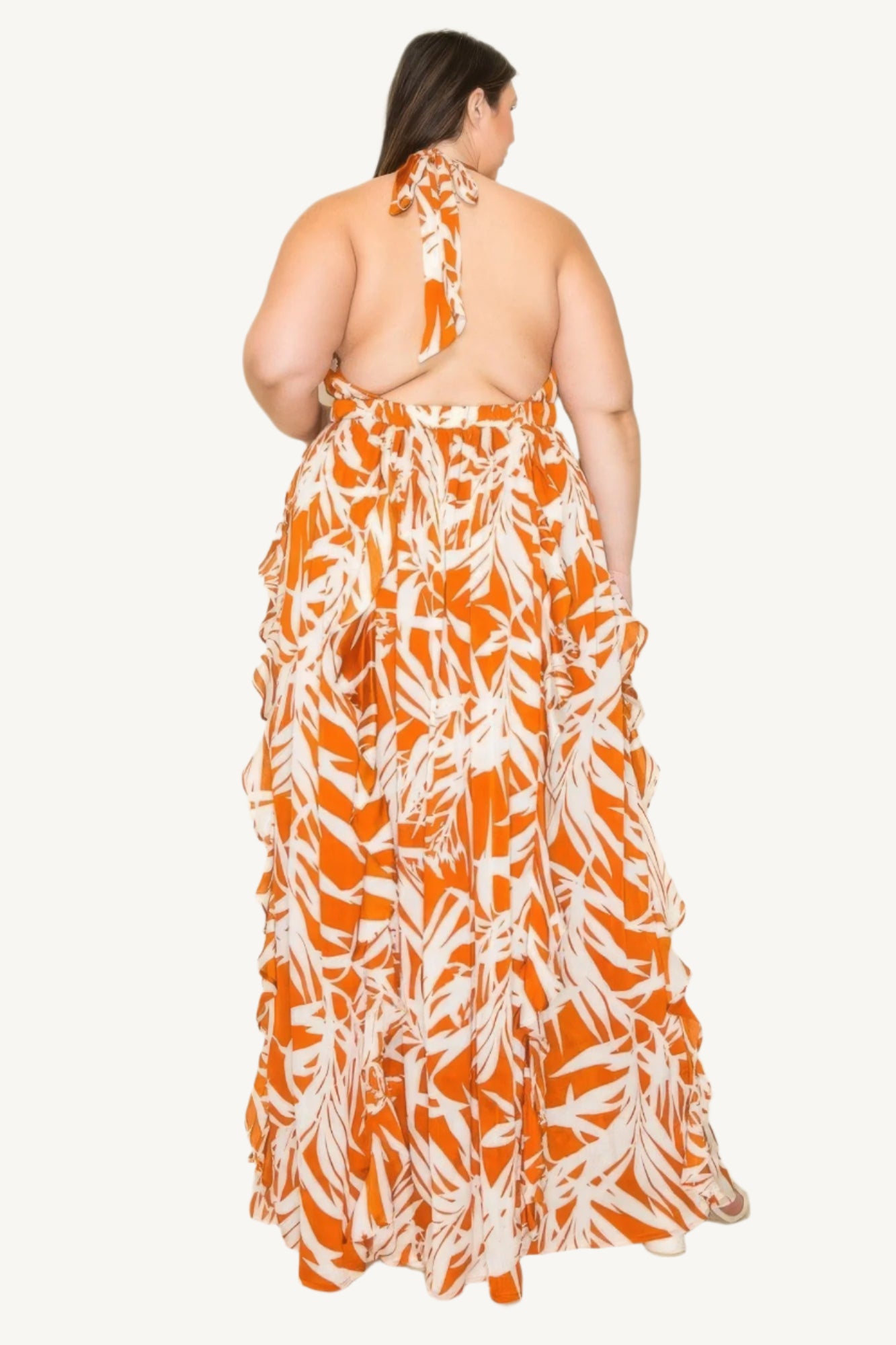 "Crinkle satin printed halter maxi dress with ruffle details, smocked waist, and front slit, offering a flowy, elegant, and flattering silhouette."