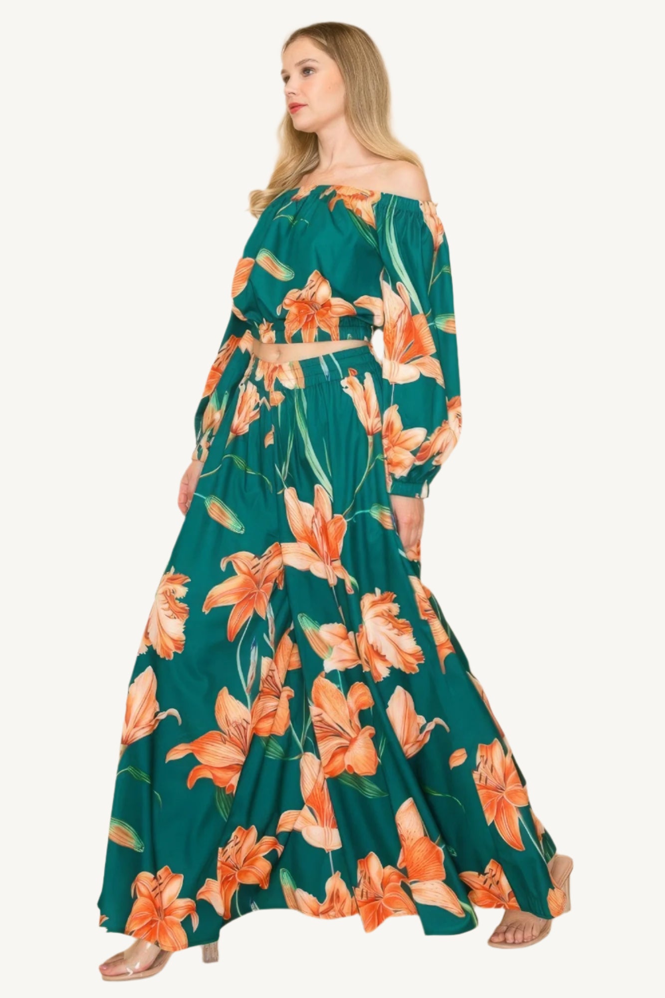 Off-shoulder top and wide-leg pants set with elastic detailing. Made from a luxurious blend of 90% polyester and 10% nylon for a chic, comfortable, and effortless look.