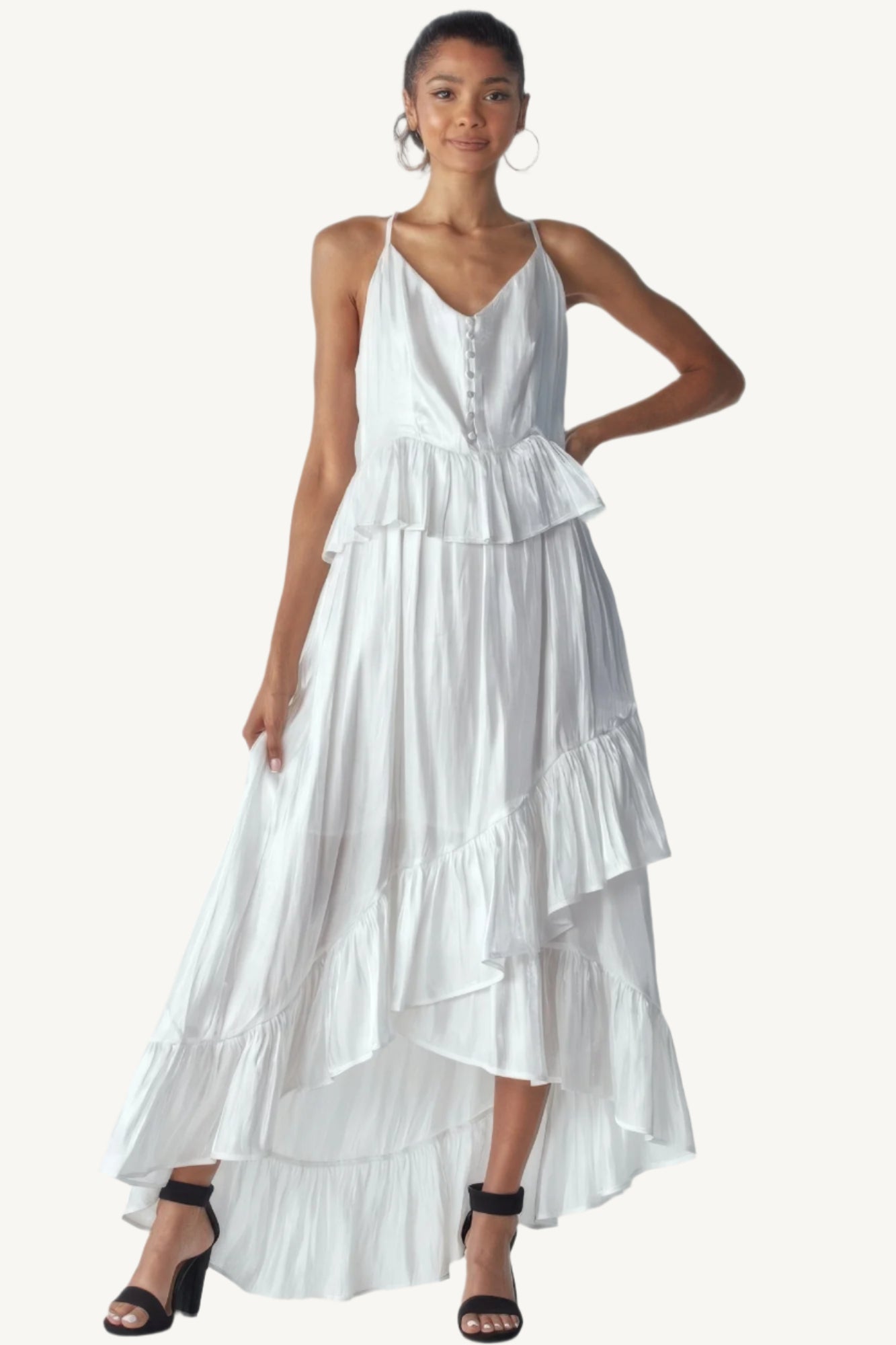 Shimmering sleeveless ruffle dress with adjustable straps, asymmetric hemline, and delicate ruffle details. Designed to dazzle with elegance and flow.