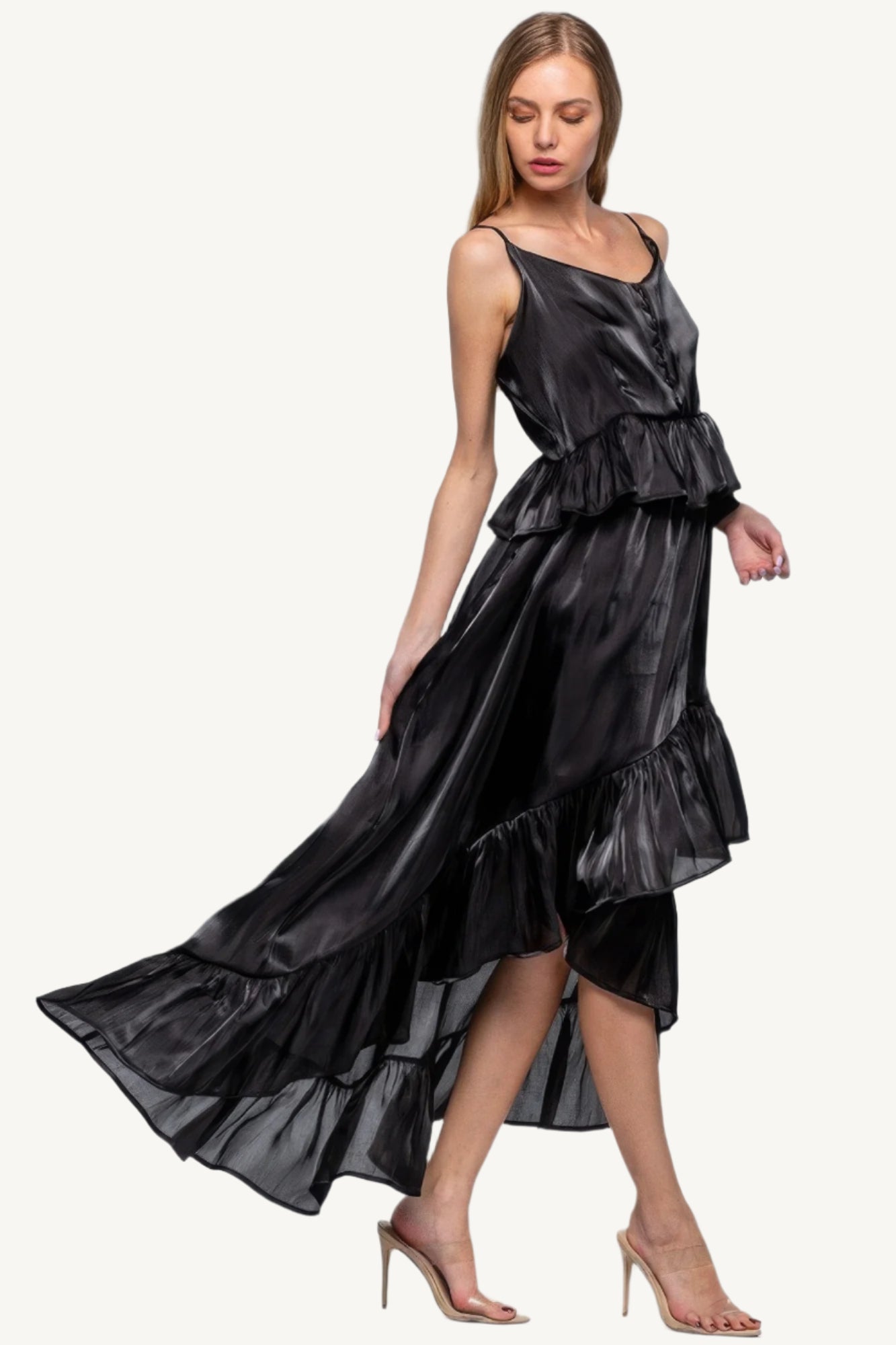 Sleeveless ruffle dress with adjustable straps and asymmetric hem, crafted from 100% polyester for a flowing, elegant silhouette with a soft shimmer.
