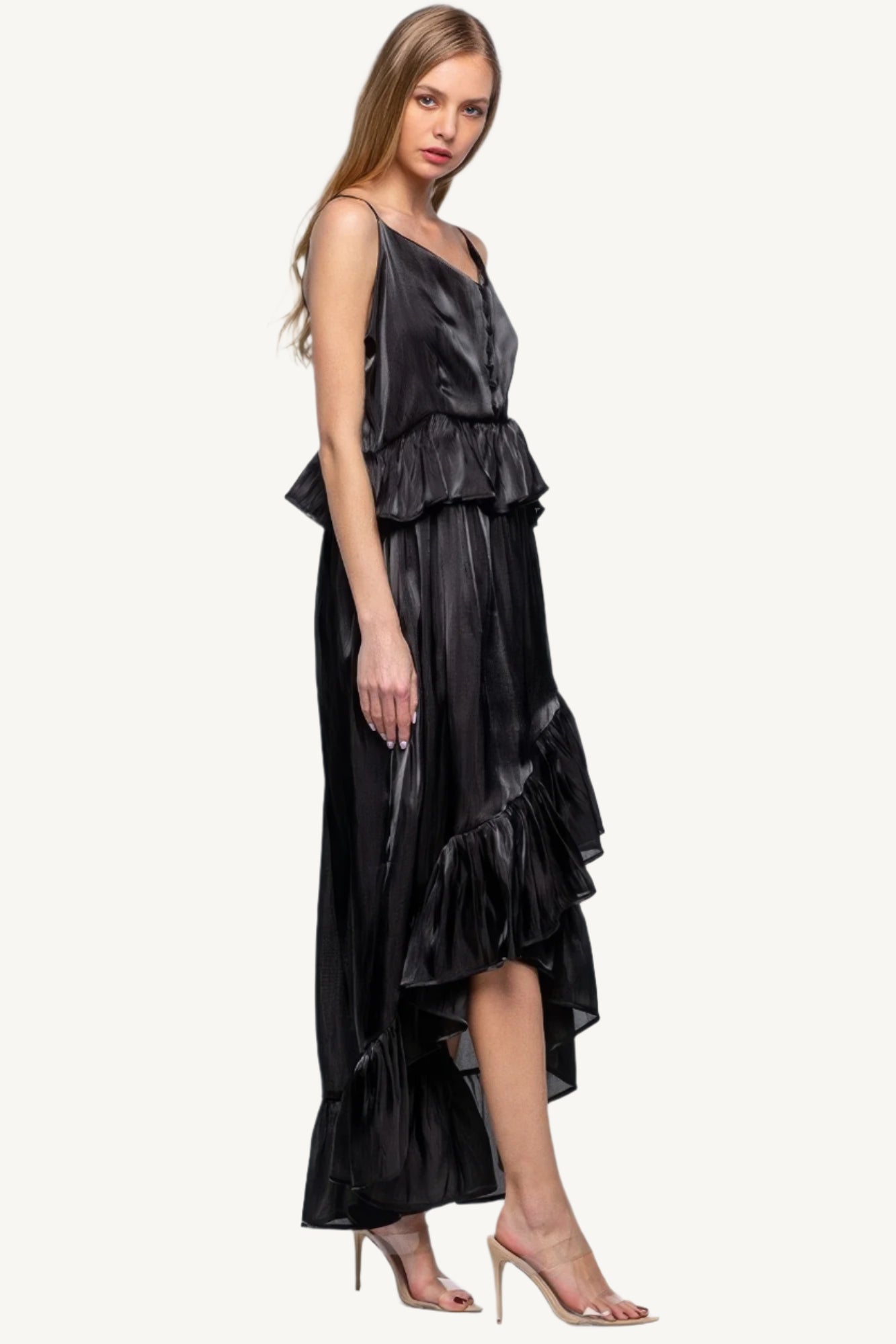 Sleeveless ruffle dress with adjustable straps and asymmetric hem, crafted from 100% polyester for a flowing, elegant silhouette with a soft shimmer.