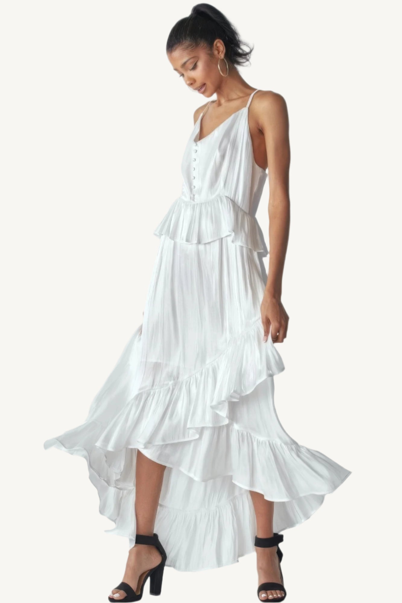 Shimmering sleeveless ruffle dress with adjustable straps, asymmetric hemline, and delicate ruffle details. Designed to dazzle with elegance and flow.