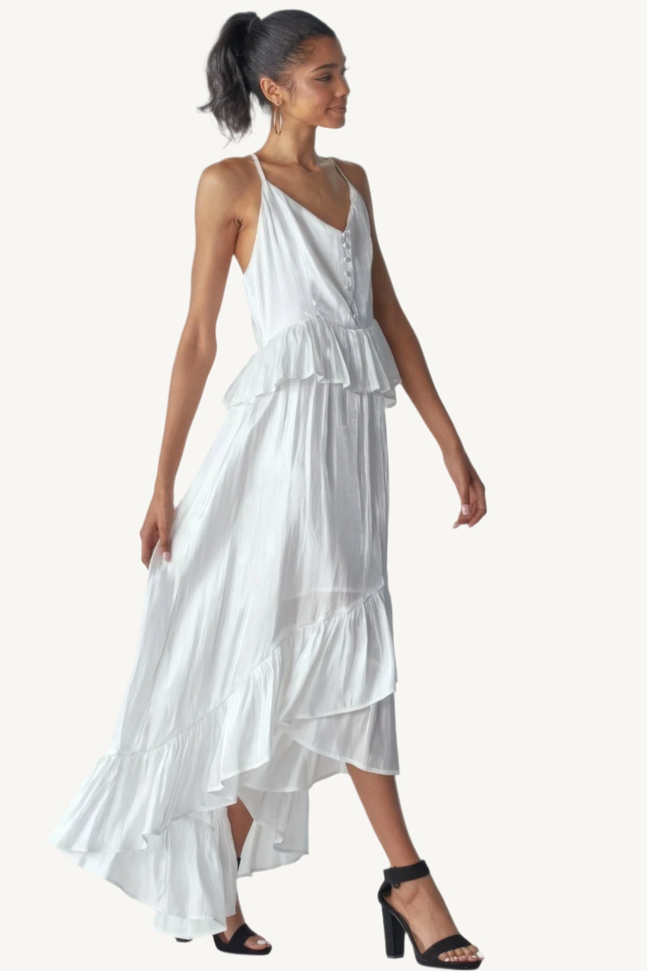 Shimmering sleeveless ruffle dress with adjustable straps, asymmetric hemline, and delicate ruffle details. Designed to dazzle with elegance and flow.
