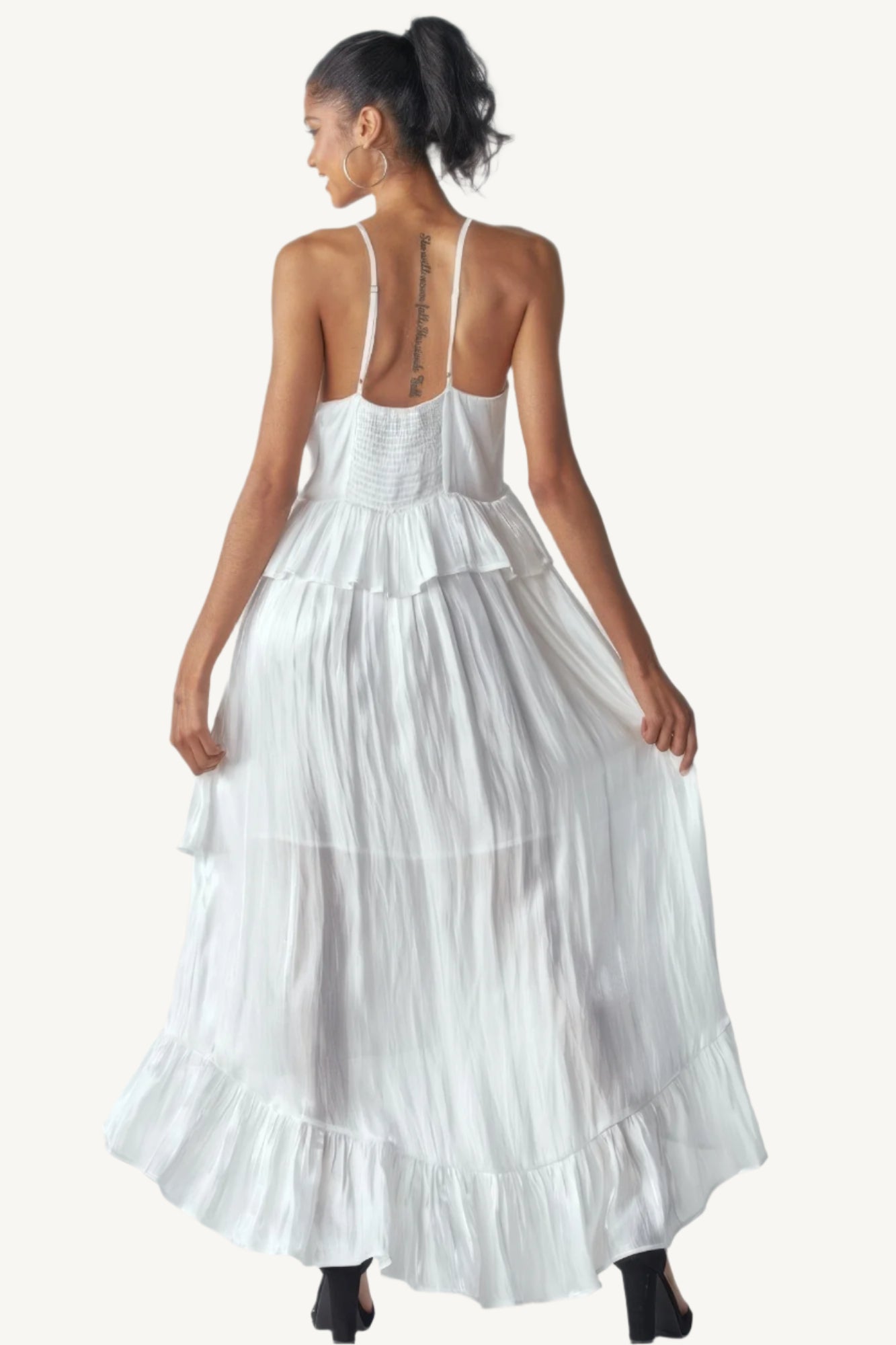 Shimmering sleeveless ruffle dress with adjustable straps, asymmetric hemline, and delicate ruffle details. Designed to dazzle with elegance and flow.