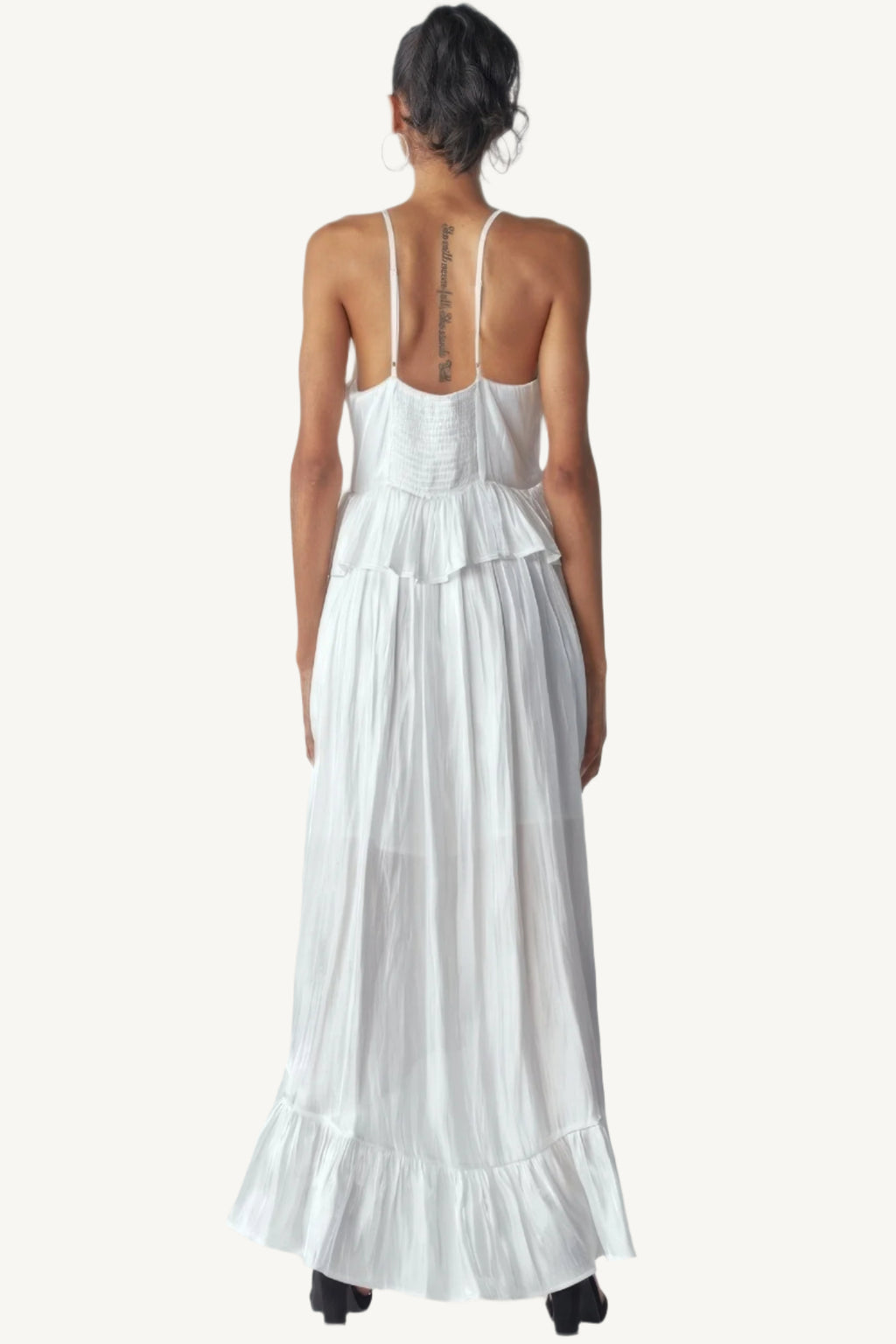 Shimmering sleeveless ruffle dress with adjustable straps, asymmetric hemline, and delicate ruffle details. Designed to dazzle with elegance and flow.