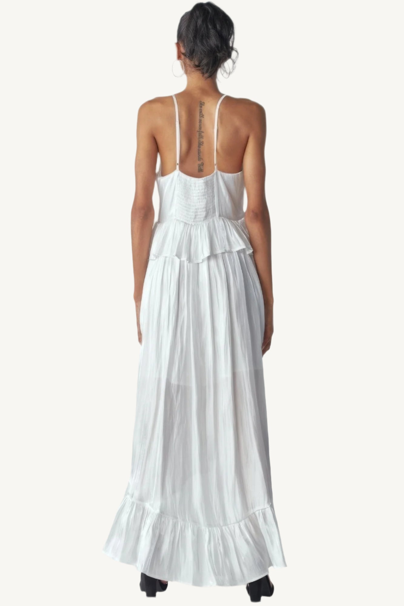 Shimmering sleeveless ruffle dress with adjustable straps, asymmetric hemline, and delicate ruffle details. Designed to dazzle with elegance and flow.