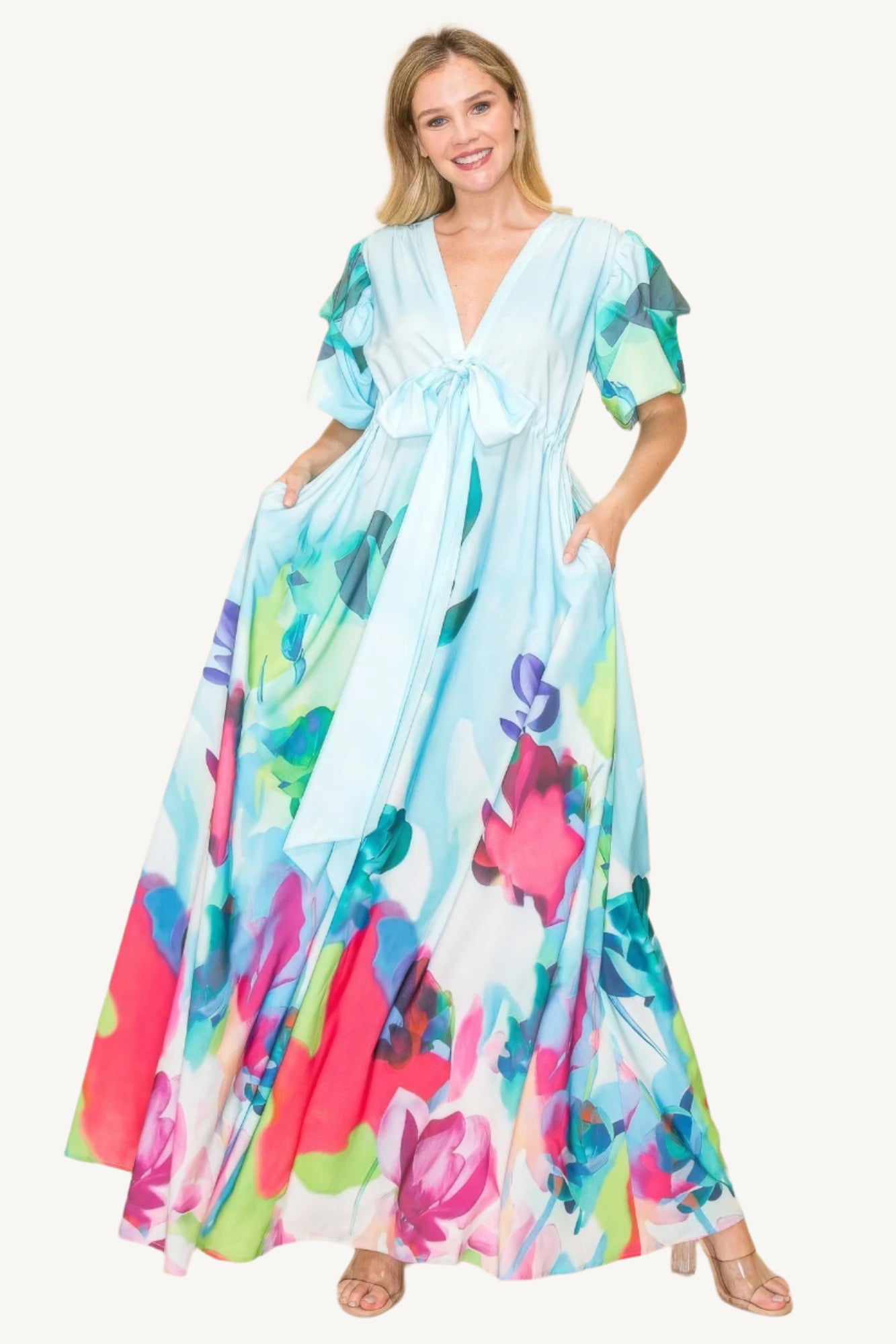 Printed V-neck maxi dress with self-tie waist ribbon, elastic waistband, and side pockets. Made from 100% polyester in a vibrant multi-colored print for a flattering, comfortable fit.