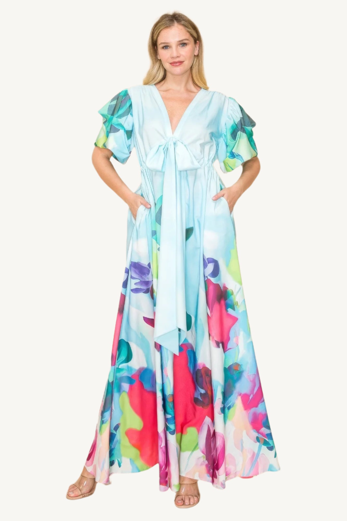 Printed V-neck maxi dress with self-tie waist ribbon, elastic waistband, and side pockets. Made from 100% polyester in a vibrant multi-colored print for a flattering, comfortable fit.