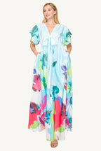 Printed V-neck maxi dress with self-tie waist ribbon, elastic waistband, and side pockets. Made from 100% polyester in a vibrant multi-colored print for a flattering, comfortable fit.