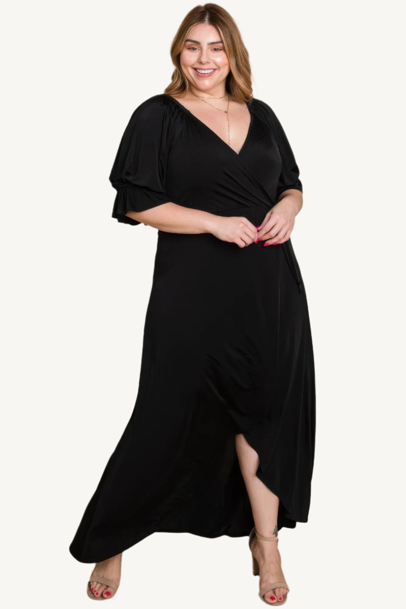 Plus-size solid color faux wrap maxi dress with Venezia fabric finish. Elegant silhouette offering style, comfort, and versatility for all occasions.