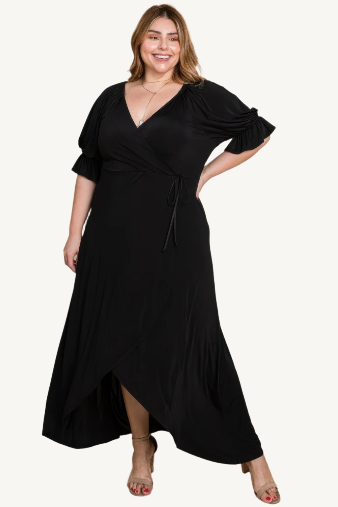 Plus-size solid color faux wrap maxi dress with Venezia fabric finish. Elegant silhouette offering style, comfort, and versatility for all occasions.