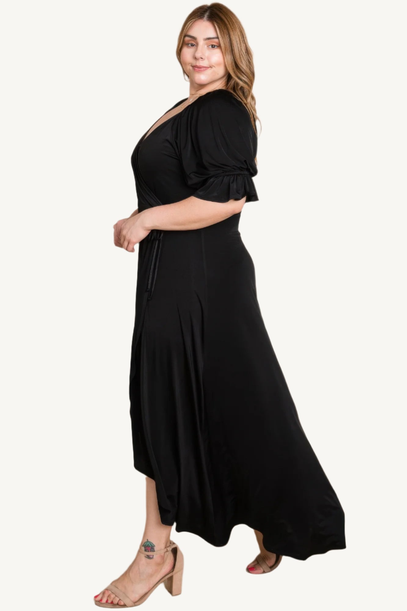 Plus-size solid color faux wrap maxi dress with Venezia fabric finish. Elegant silhouette offering style, comfort, and versatility for all occasions.