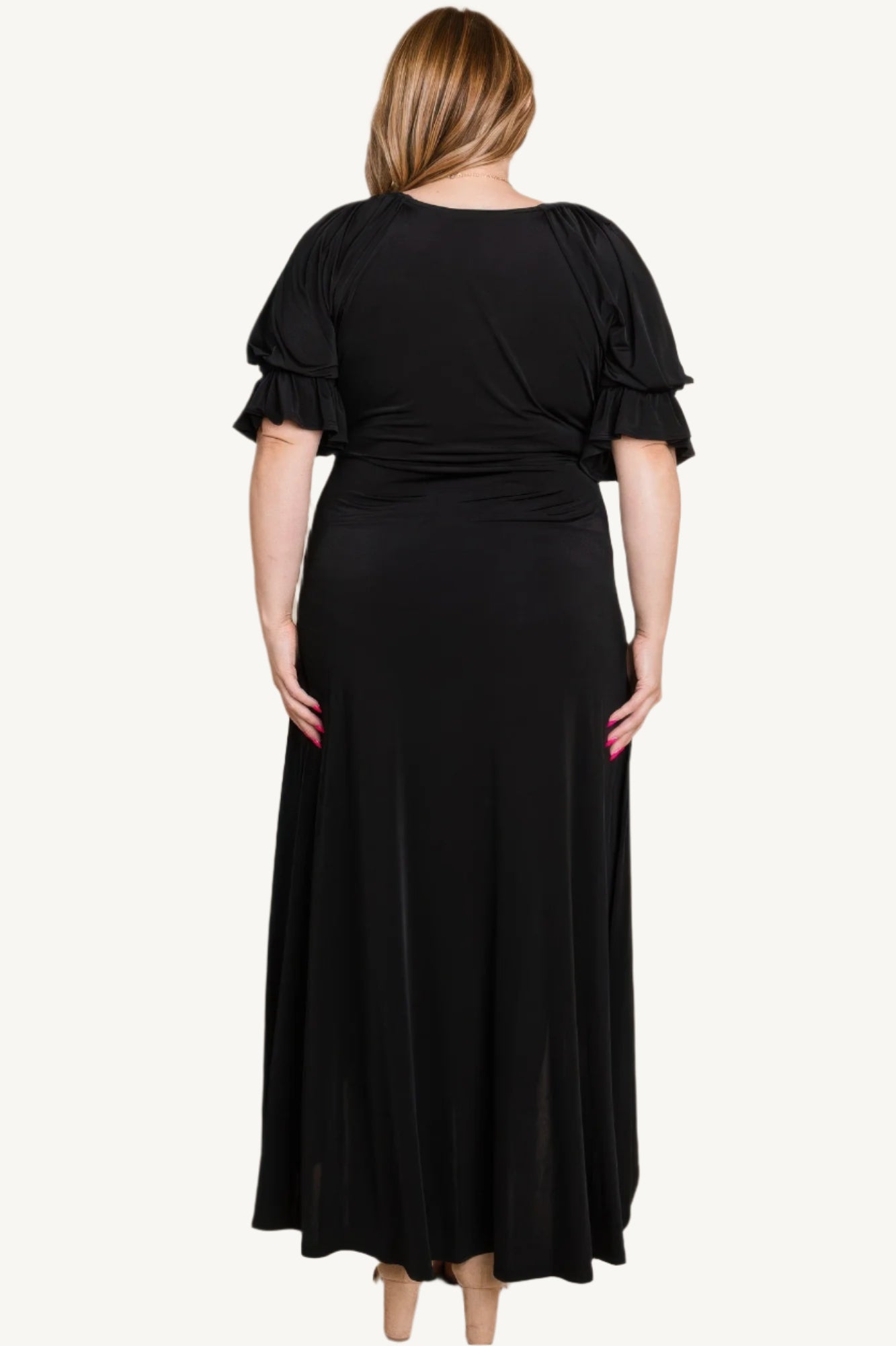 Plus-size solid color faux wrap maxi dress with Venezia fabric finish. Elegant silhouette offering style, comfort, and versatility for all occasions.