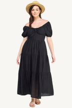 Plus-size black tiered maxi dress with front tie, puff sleeves, and flowing silhouette. Lightweight polyester fabric for breathable, elegant comfort and style.
