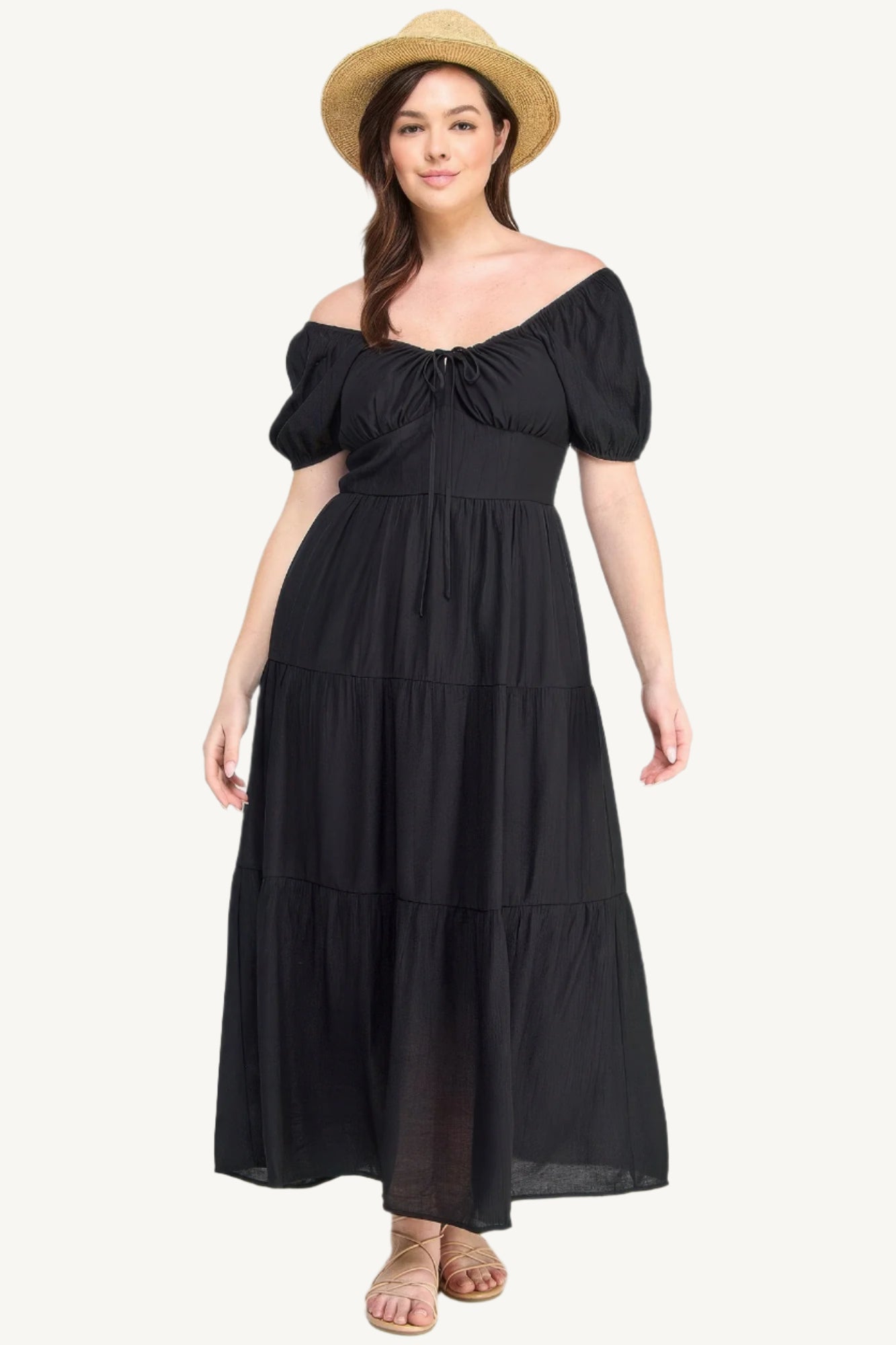 Plus-size black tiered maxi dress with front tie, puff sleeves, and flowing silhouette. Lightweight polyester fabric for breathable, elegant comfort and style.