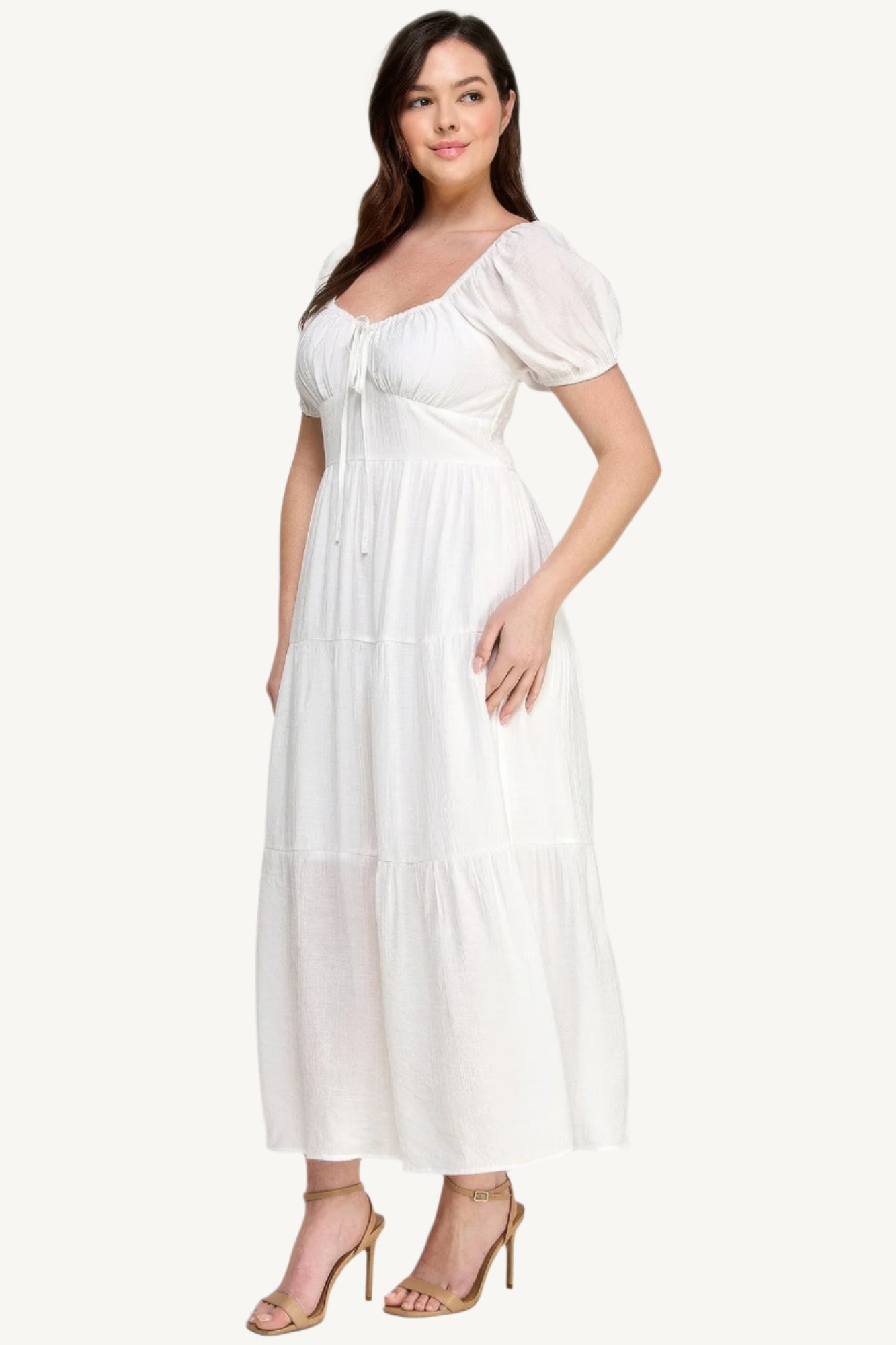 "White plus size tiered maxi dress with puff sleeves and front tie detail, crafted from lightweight polyester for a fresh and feminine look."