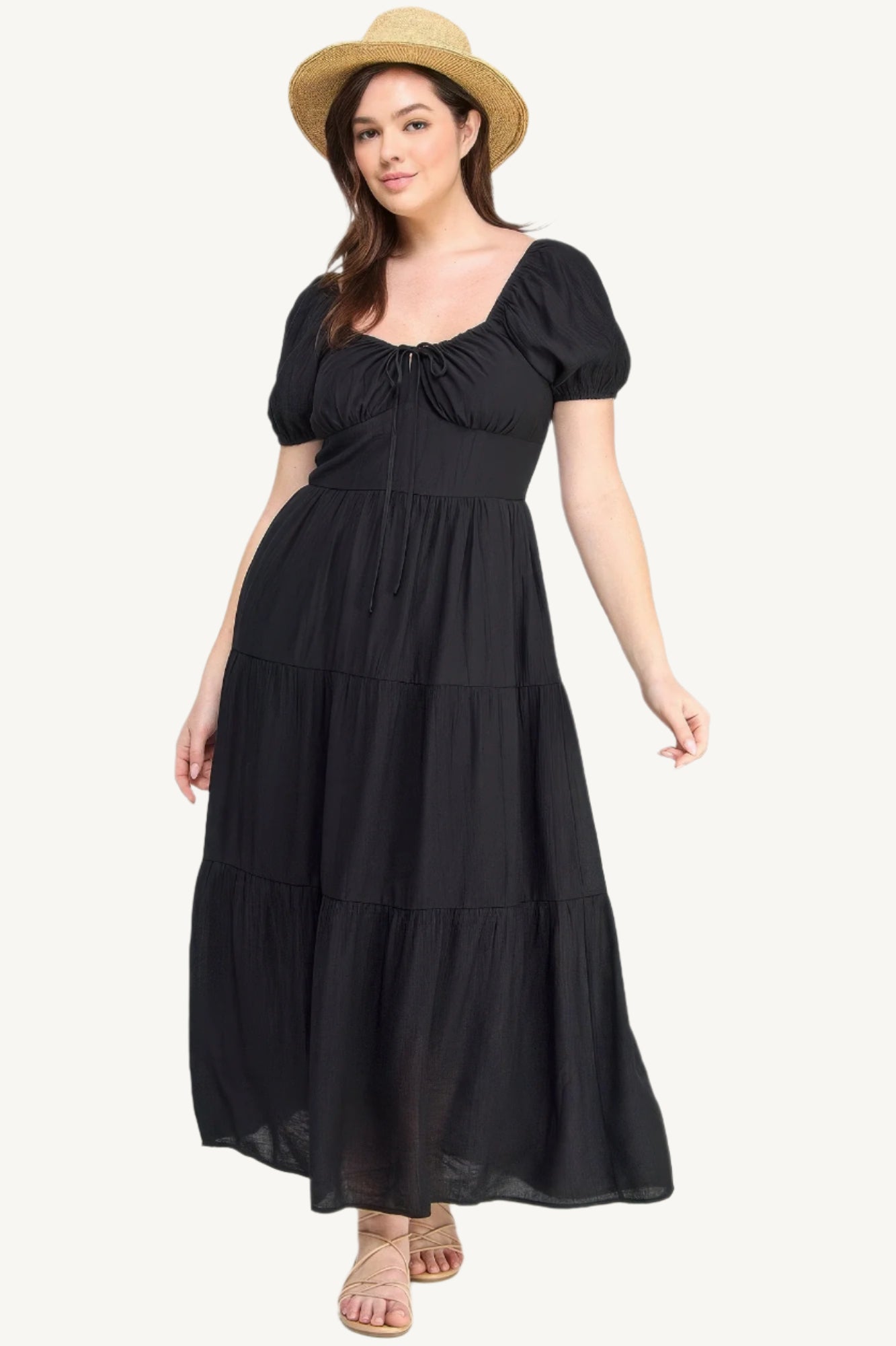 Plus-size black tiered maxi dress with front tie, puff sleeves, and flowing silhouette. Lightweight polyester fabric for breathable, elegant comfort and style.