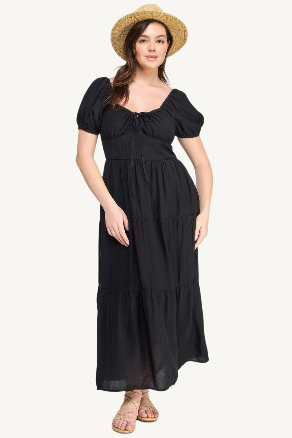 Plus-size black tiered maxi dress with front tie, puff sleeves, and flowing silhouette. Lightweight polyester fabric for breathable, elegant comfort and style.